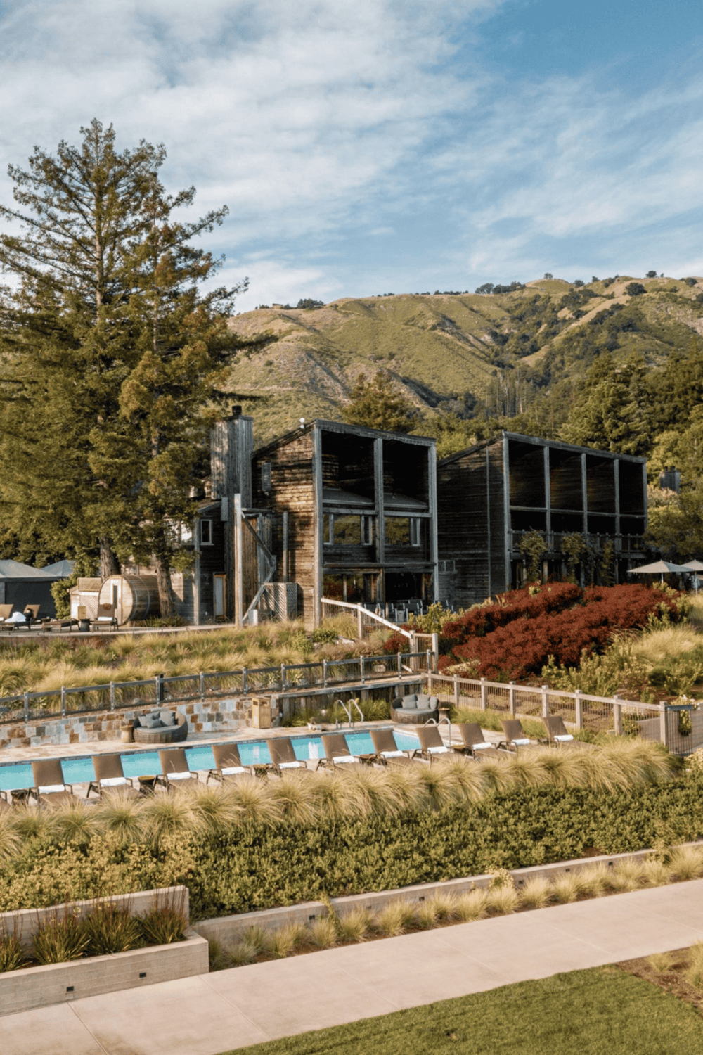 Modern outdoor pool area with mountain views and stylish lounge chairs, perfect for relaxation and outdoor living.