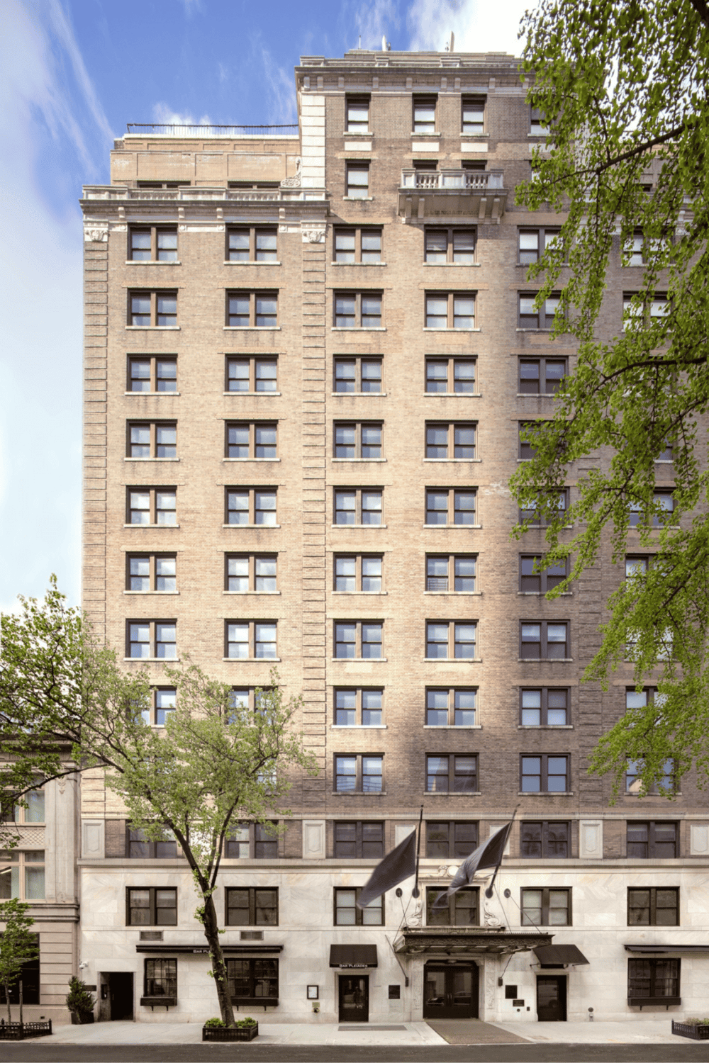 High-rise hotel building with city street view, overlooking tall windows and classic architecture.
