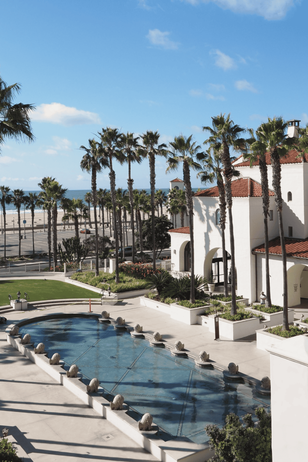 Luxurious coastal resort with palm trees, ocean view, and elegant architecture.