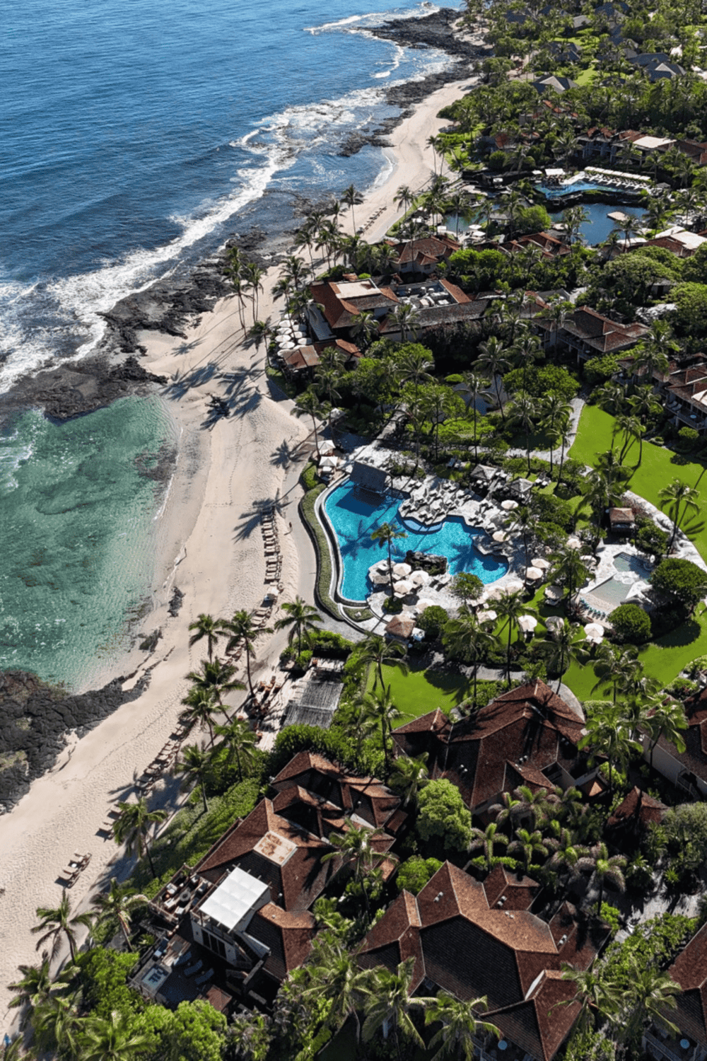 Oceanfront resort with swimming pool and lush tropical landscape in a coastal paradise.
