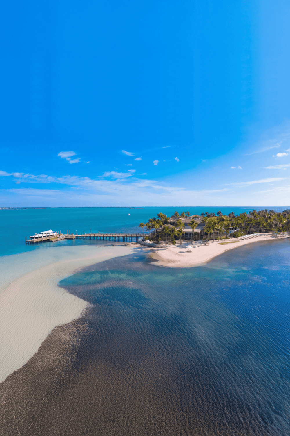 Seaside resort with sandy beaches, turquoise waters, and tropical palm trees, perfect for relaxation and vacation.