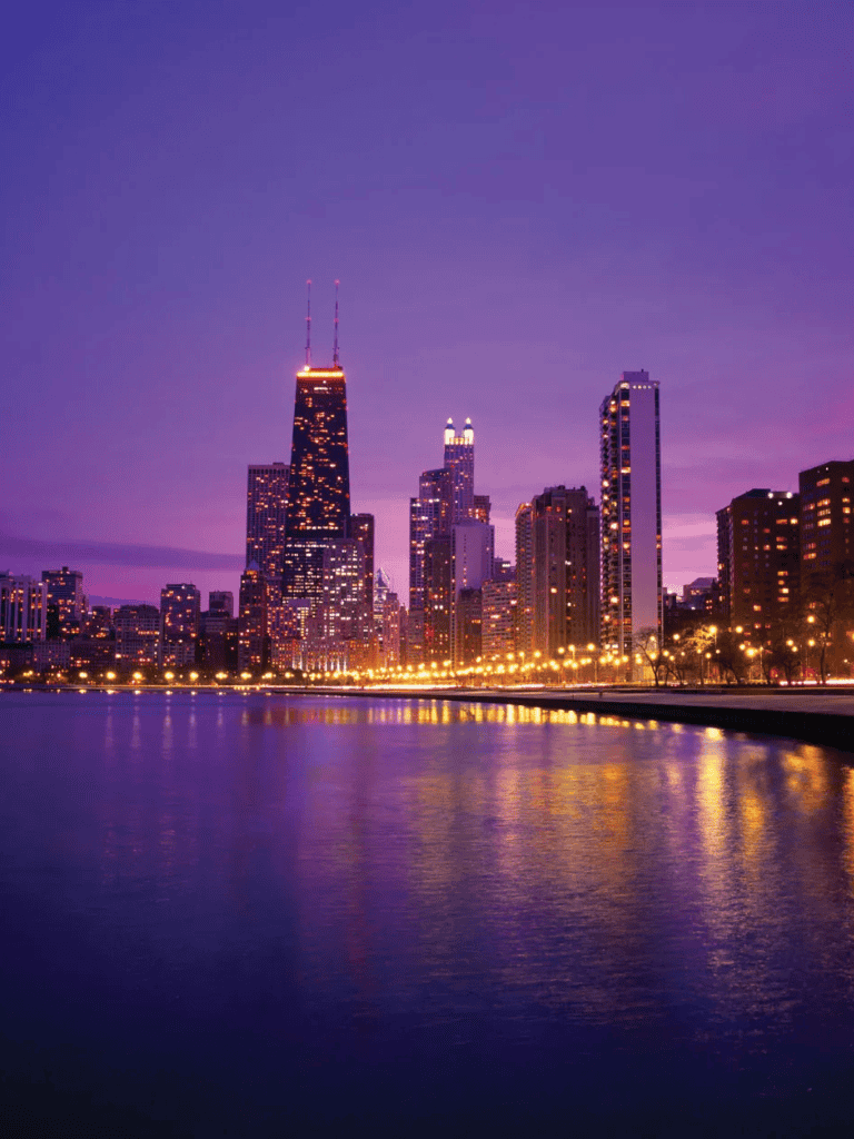 1. Chicago skyline at dusk with city lights reflected on the lake, vibrant purple sky, modern skyscrapers.