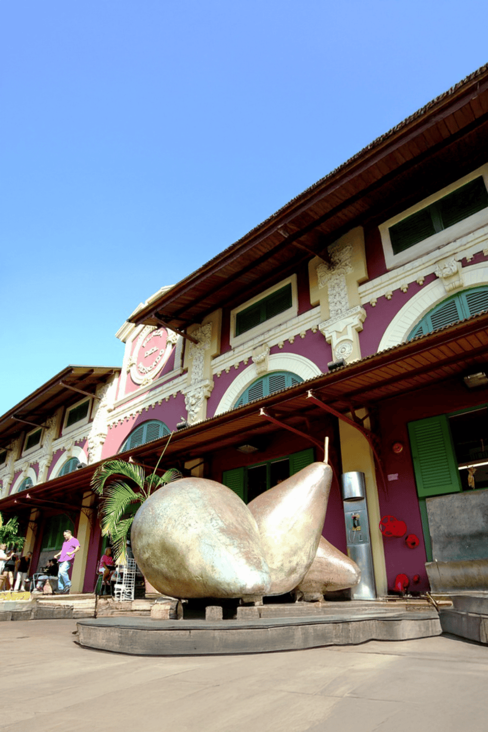 Shell sculpture outside colorful building, QuestForDirections tourism landmark.