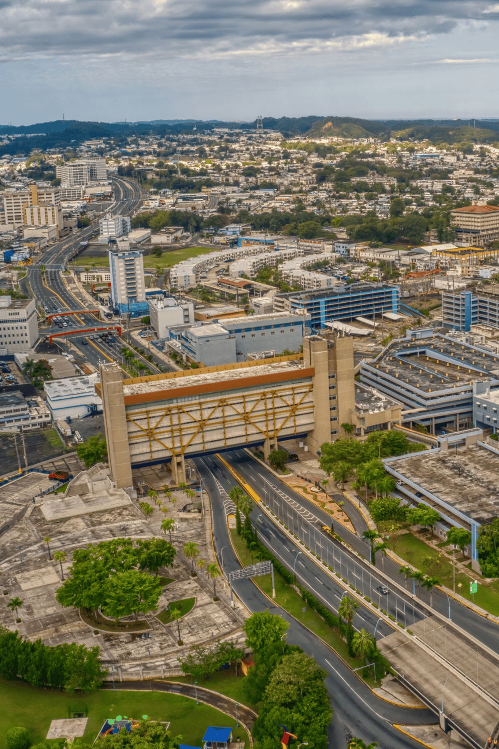 Vibrant cityscape with urban roads, buildings, and green spaces in a modern downtown area.