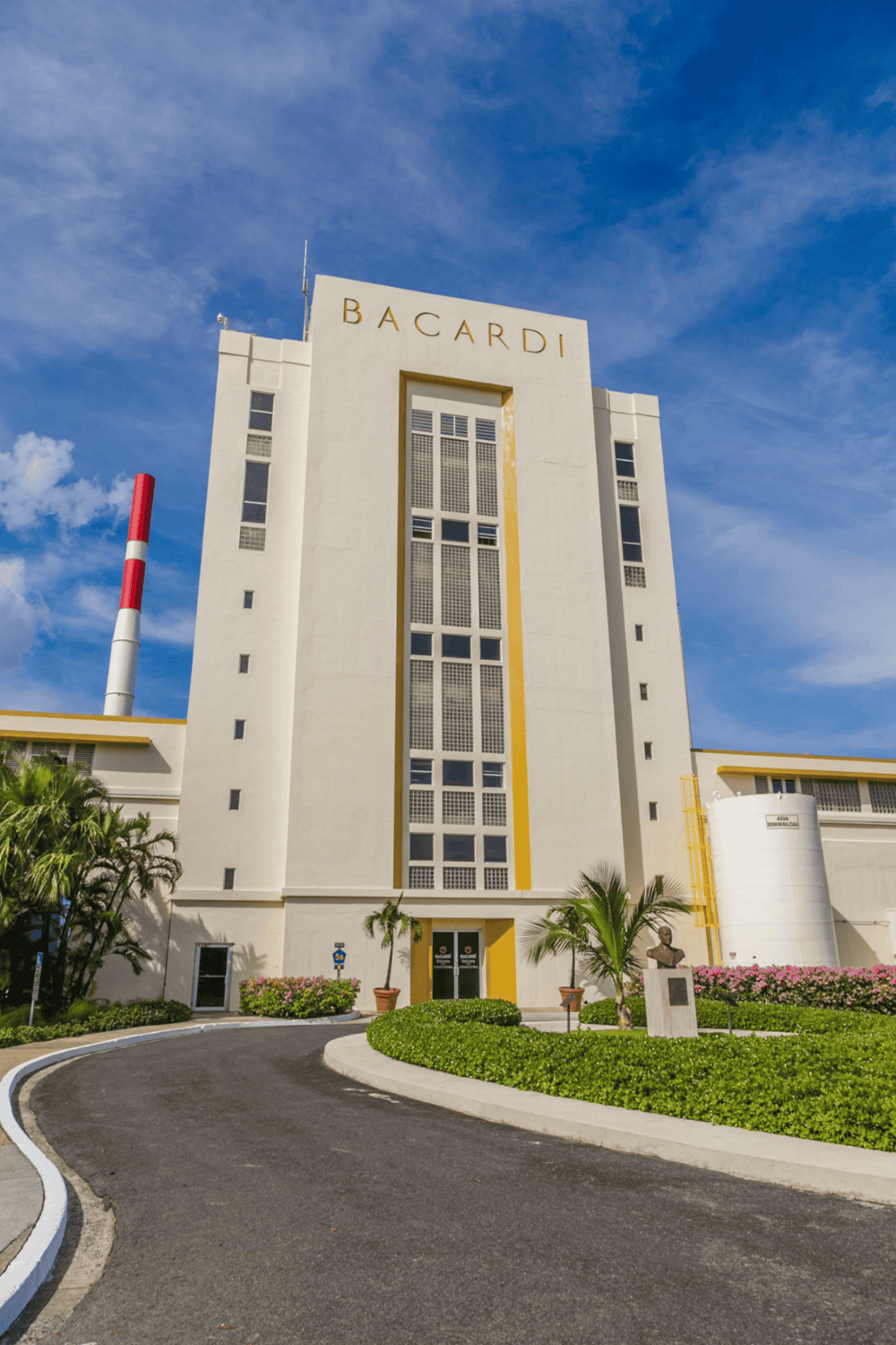 Modern Bacardi brewery building under blue sky, showcasing beverage manufacturing facility.