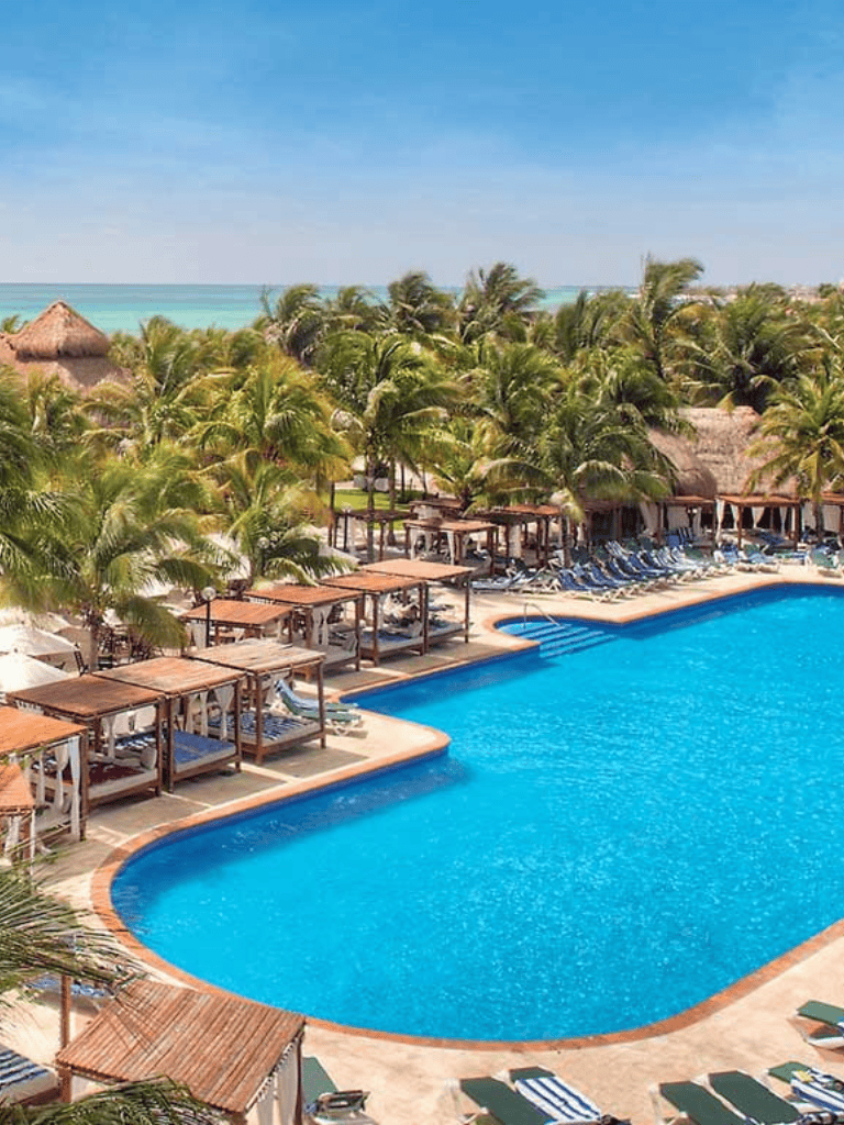 Luxurious tropical poolside resort at QuestForDirections with palm trees and ocean views.