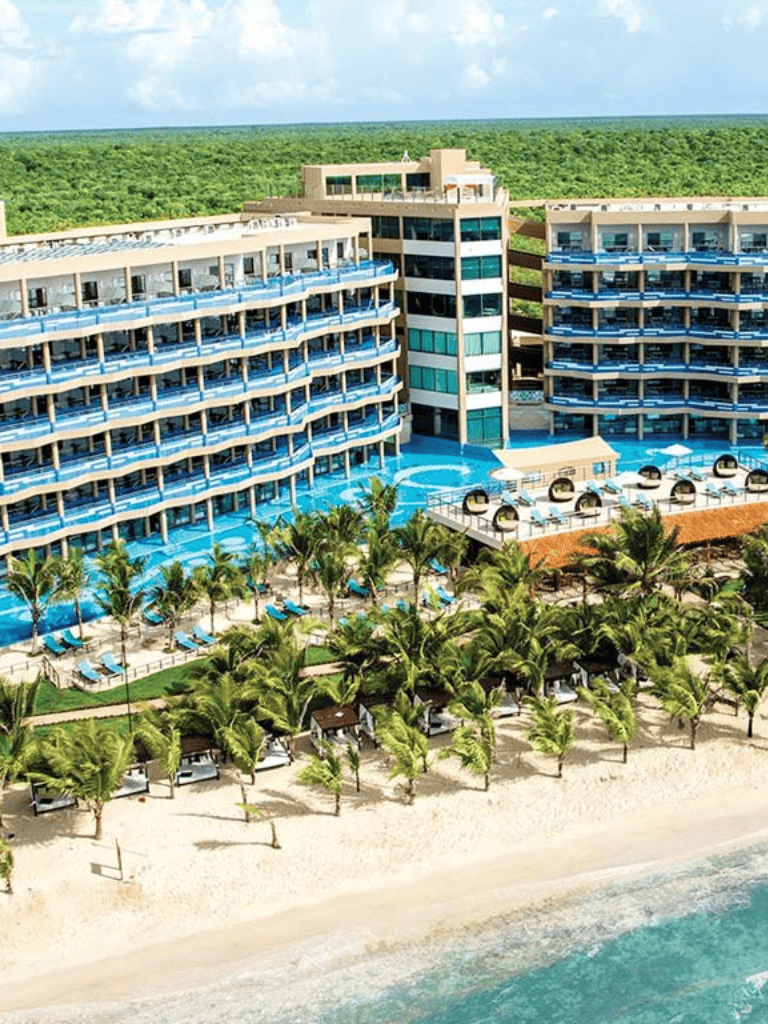 Spacious beachfront resort with ocean-view rooms and lush tropical landscaping.