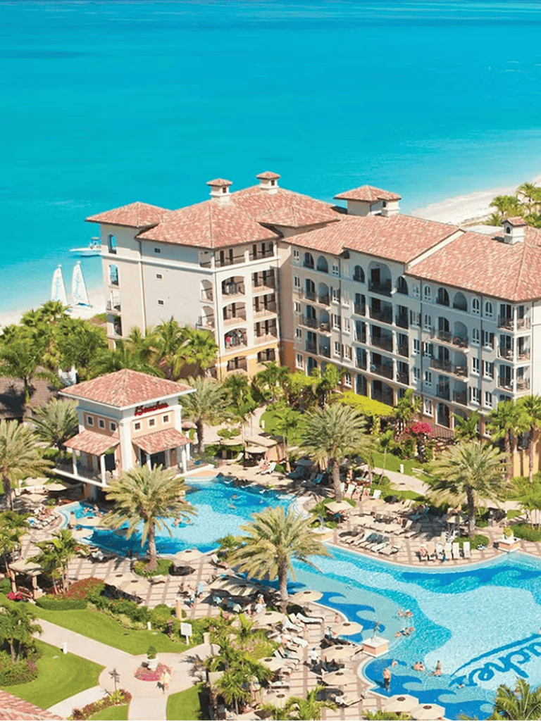 Luxurious beachfront resort with pools, palm trees, and ocean views at QuestForDirections.