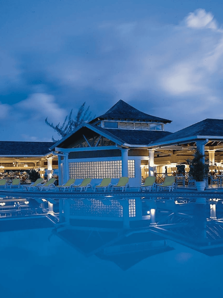 Relaxing poolside view at Quest for Directions resort in the evening.