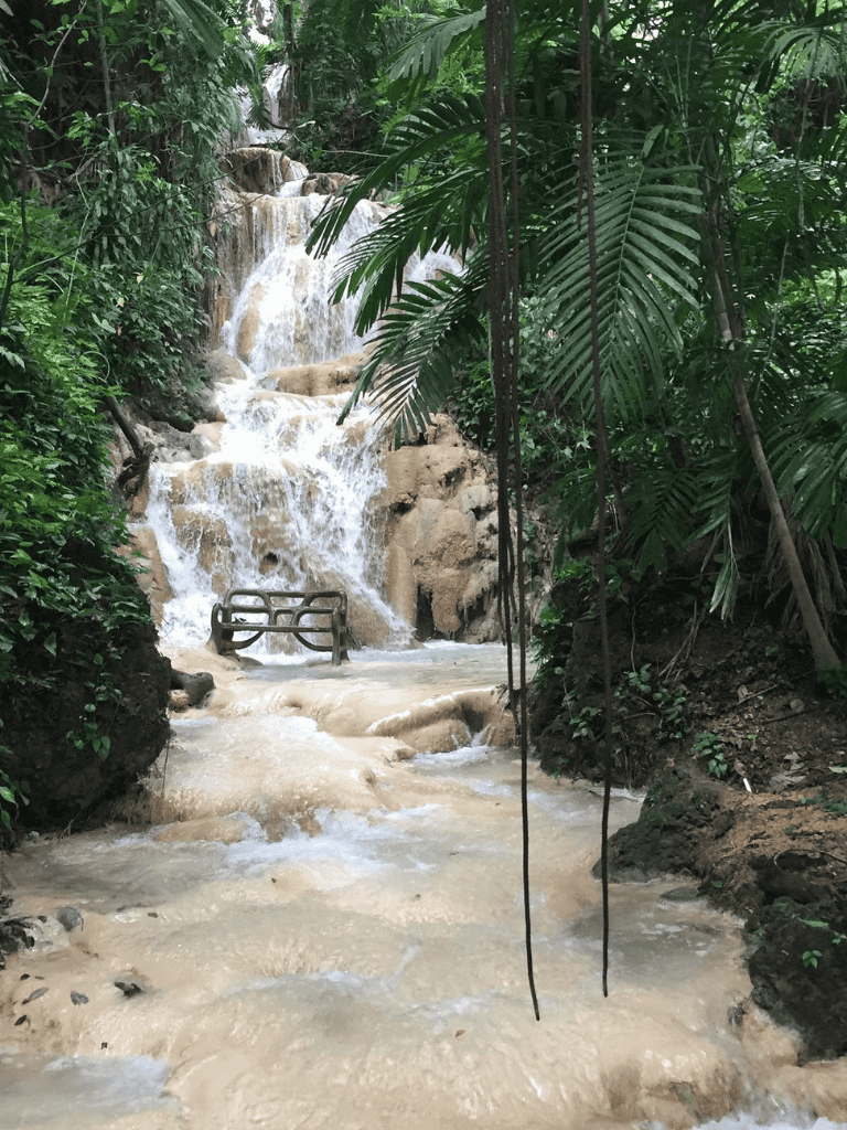 Vibrant jungle waterfall with lush greenery and natural stone, perfect for adventure and nature exploration.