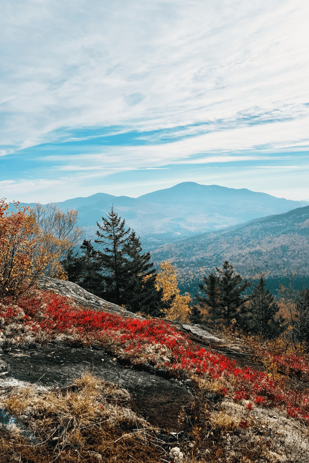 Vibrant mountain landscape with colorful autumn foliage and clear sky, ideal for outdoor adventures and scenic exploration.