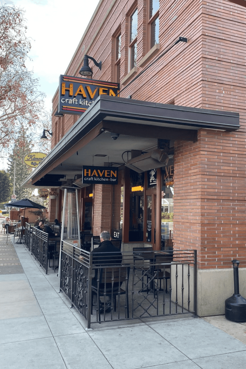1. Cozy outdoor seating at Haven craft kitchen and bar on a city sidewalk.