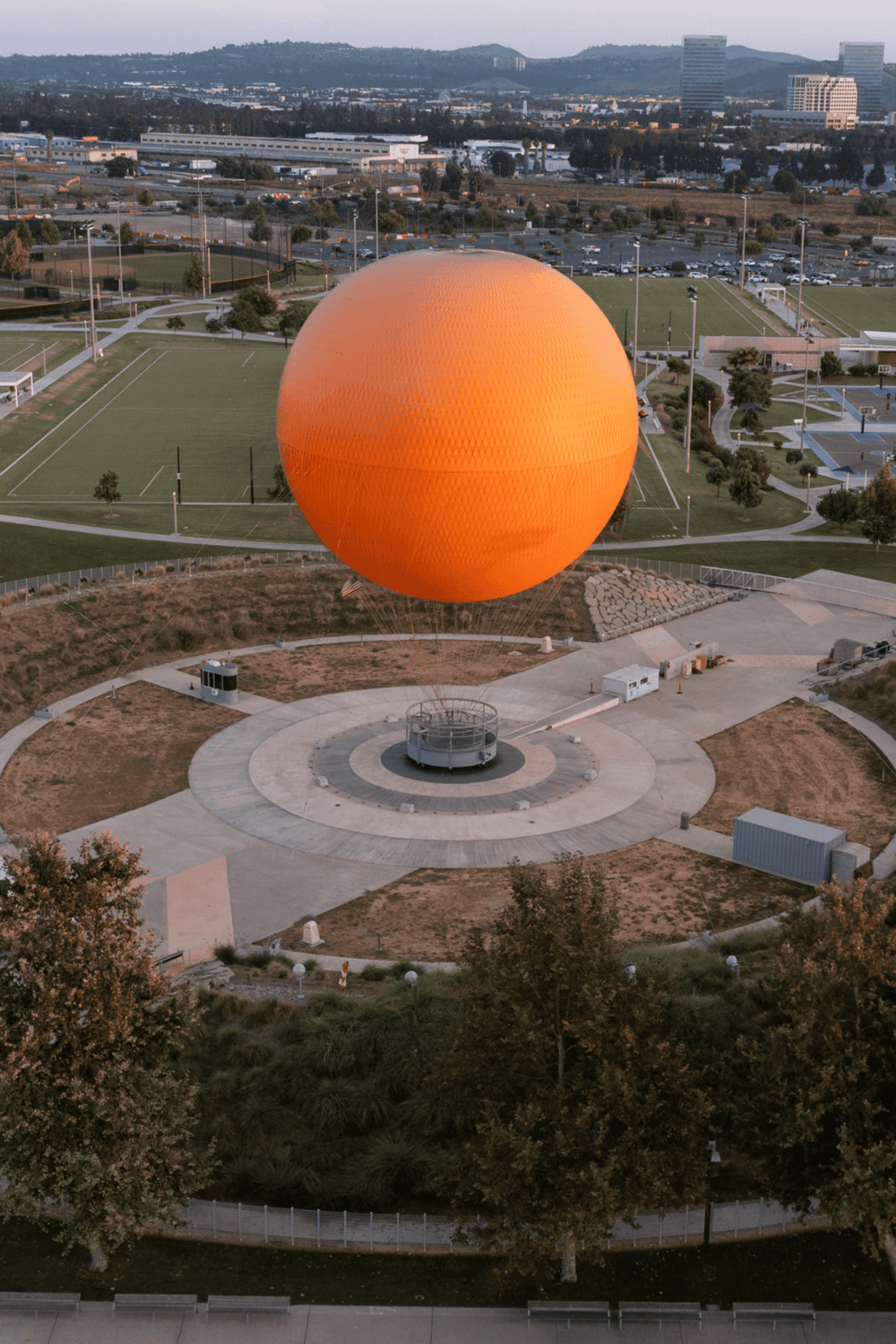 Hot air balloon tethered at Quest for Directions outdoor site, California.