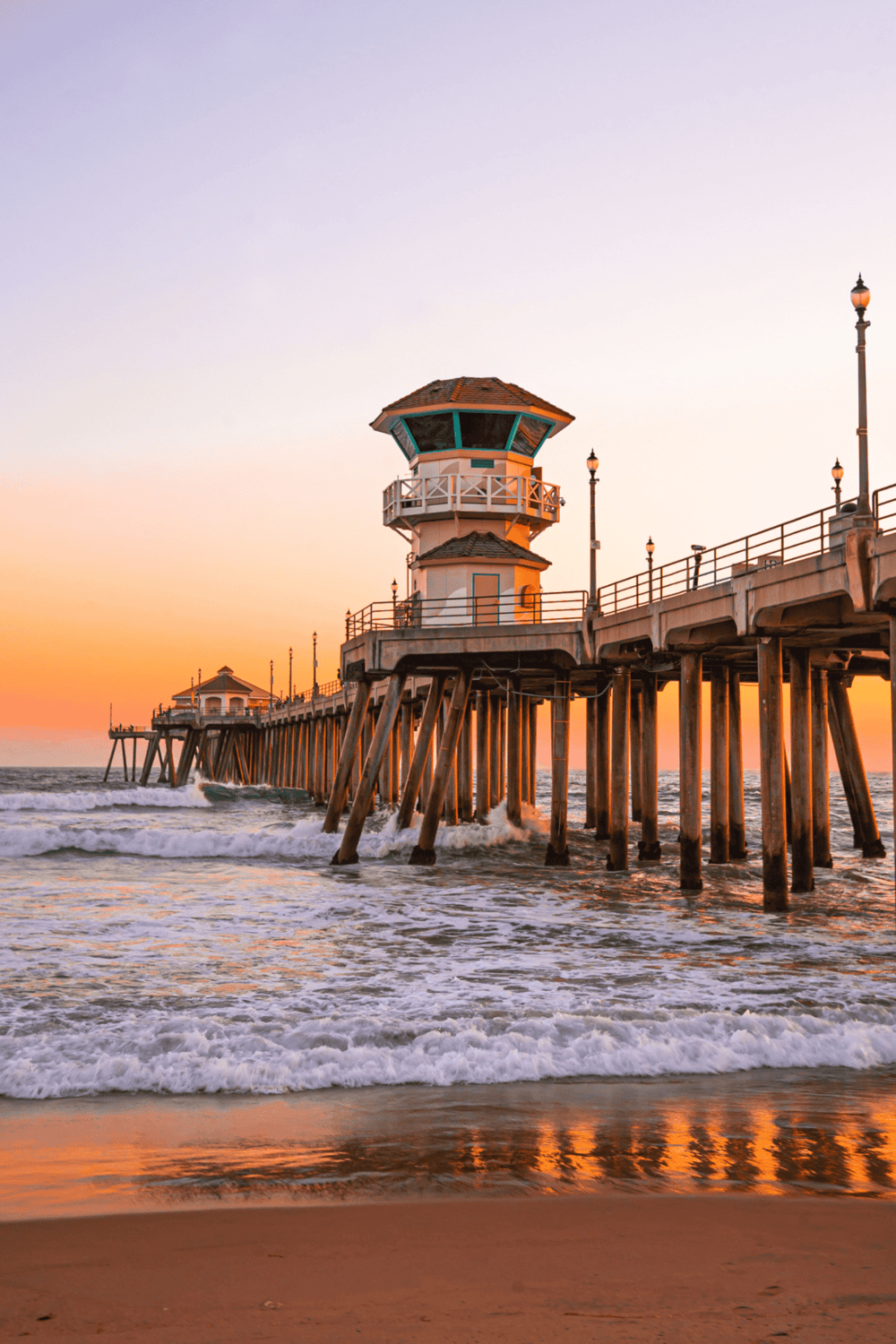 Beautiful fishing pier at sunset, coastal ocean view, Southern California beach scene.