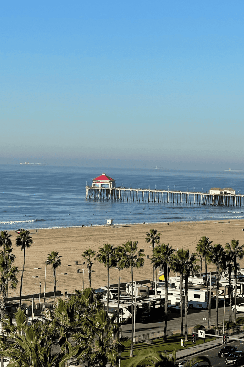 Bright seaside pier with a red-roofed pavilion in sunny Southern California.