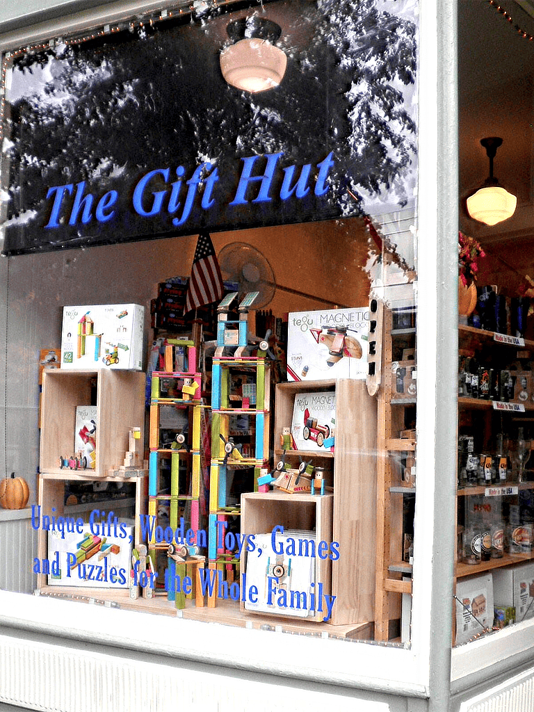 Colorful wooden toys and gift shop display at The Gift Hut for family-friendly gifts and puzzles.