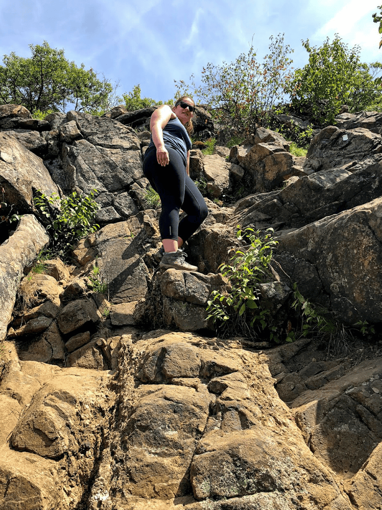 Climbing rocky terrain during an outdoor adventure.