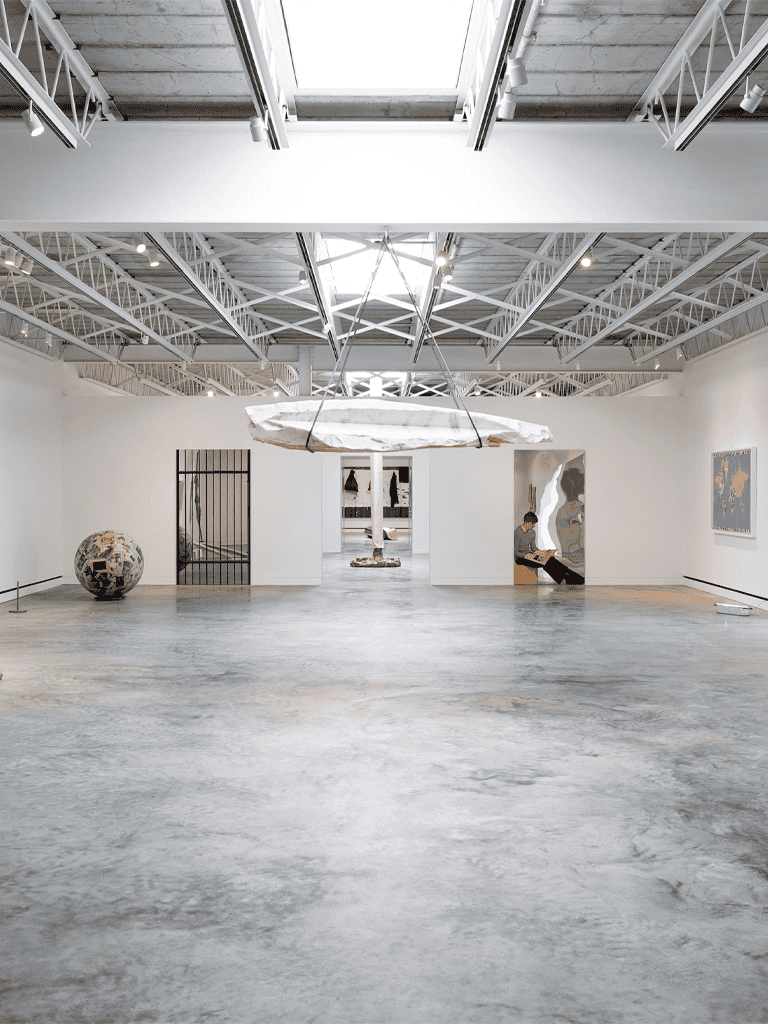 Modern art gallery interior showcasing contemporary artworks, sculptures, and minimalistic design.