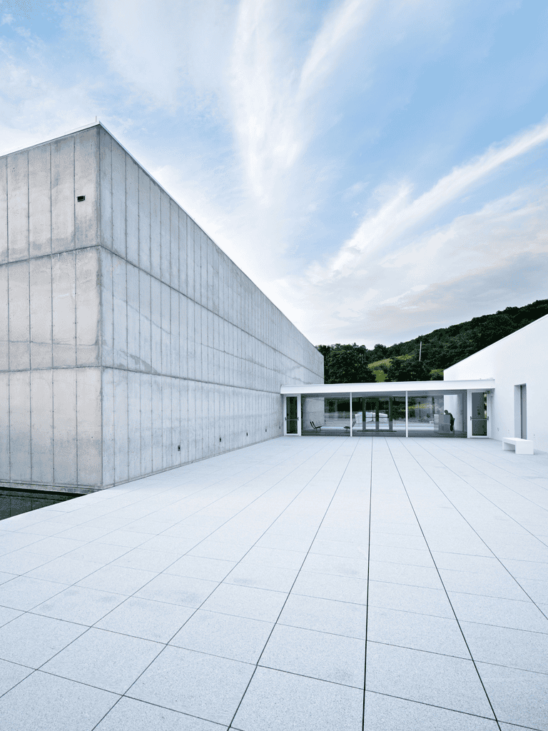 Modern minimalist building exterior with clean lines and open space, perfect for architecture and design inspiration.