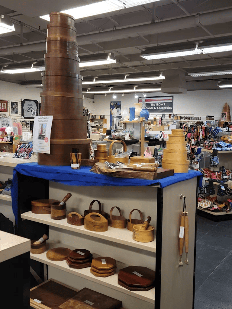 Wooden kitchenware and collectibles display in thrift store interior.