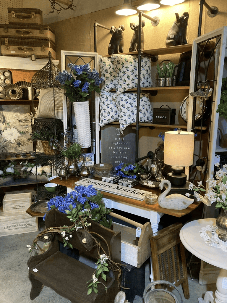 Vintage home decor and antique furniture store interior, curated with floral accents and rustic accents.