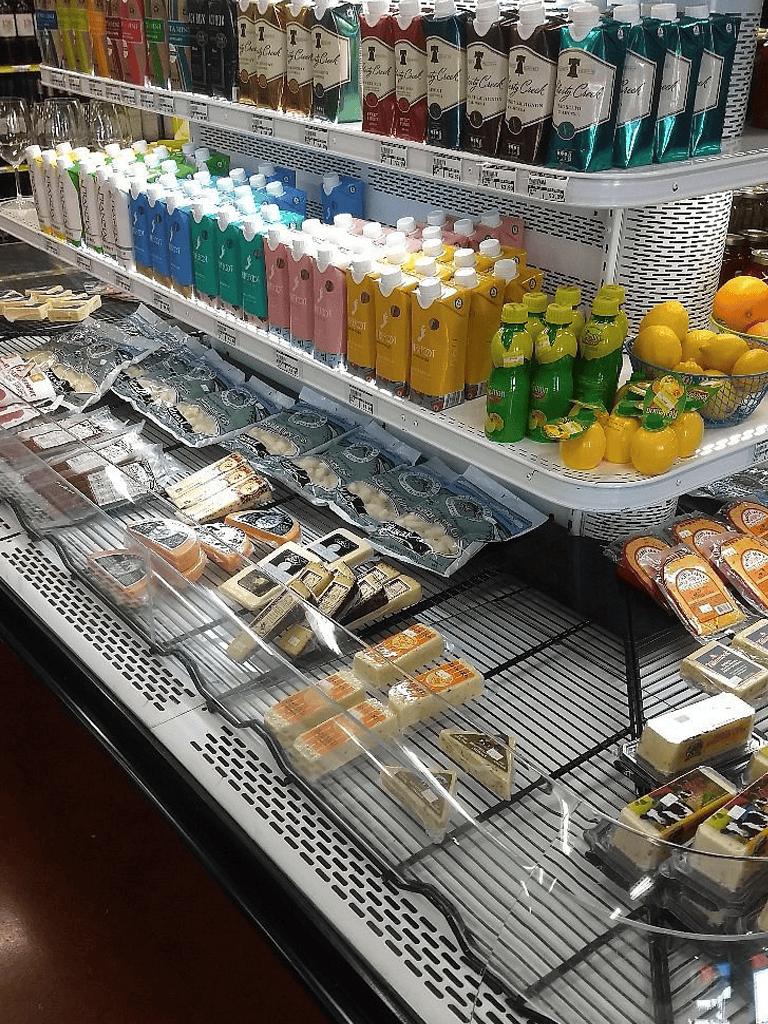 Cream beverages and dairy drinks in grocery store aisle.