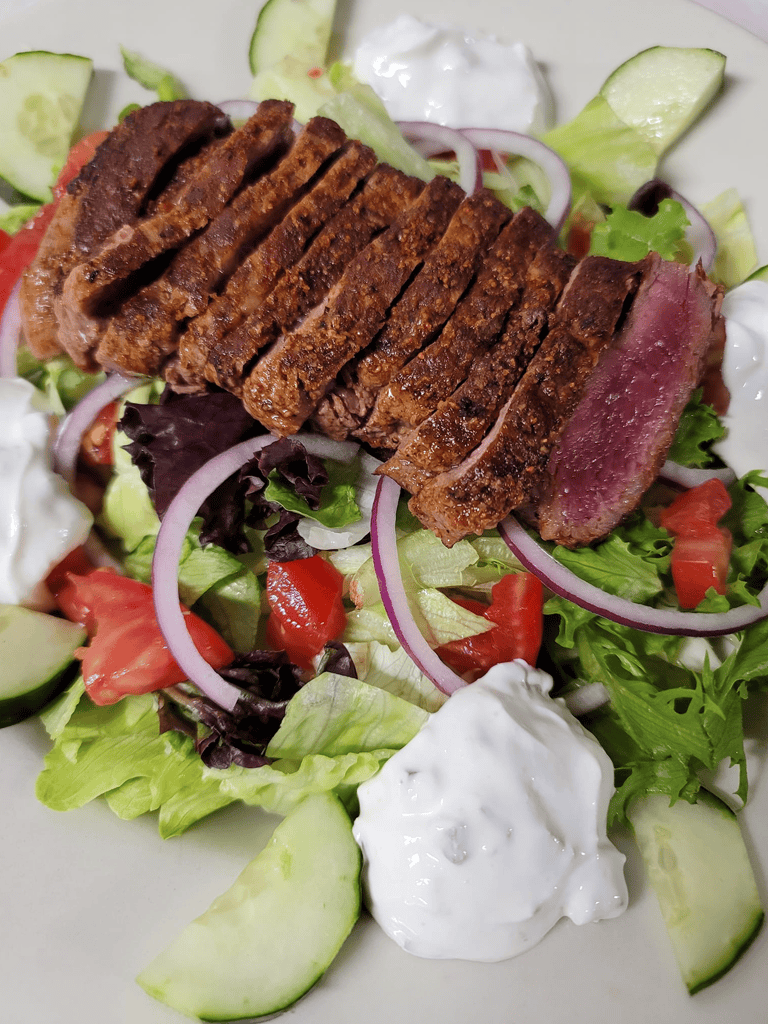 Juicy Steak Salad with Fresh Vegetables and Creamy Dressing - Healthy and Delicious.