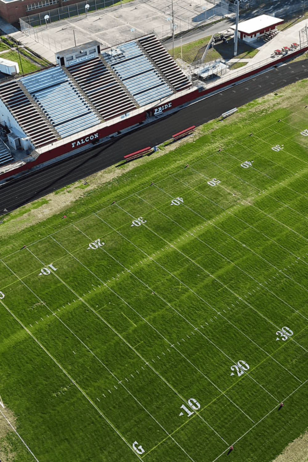 Aerial view of Falcon Pride football stadium with field and bleachers.