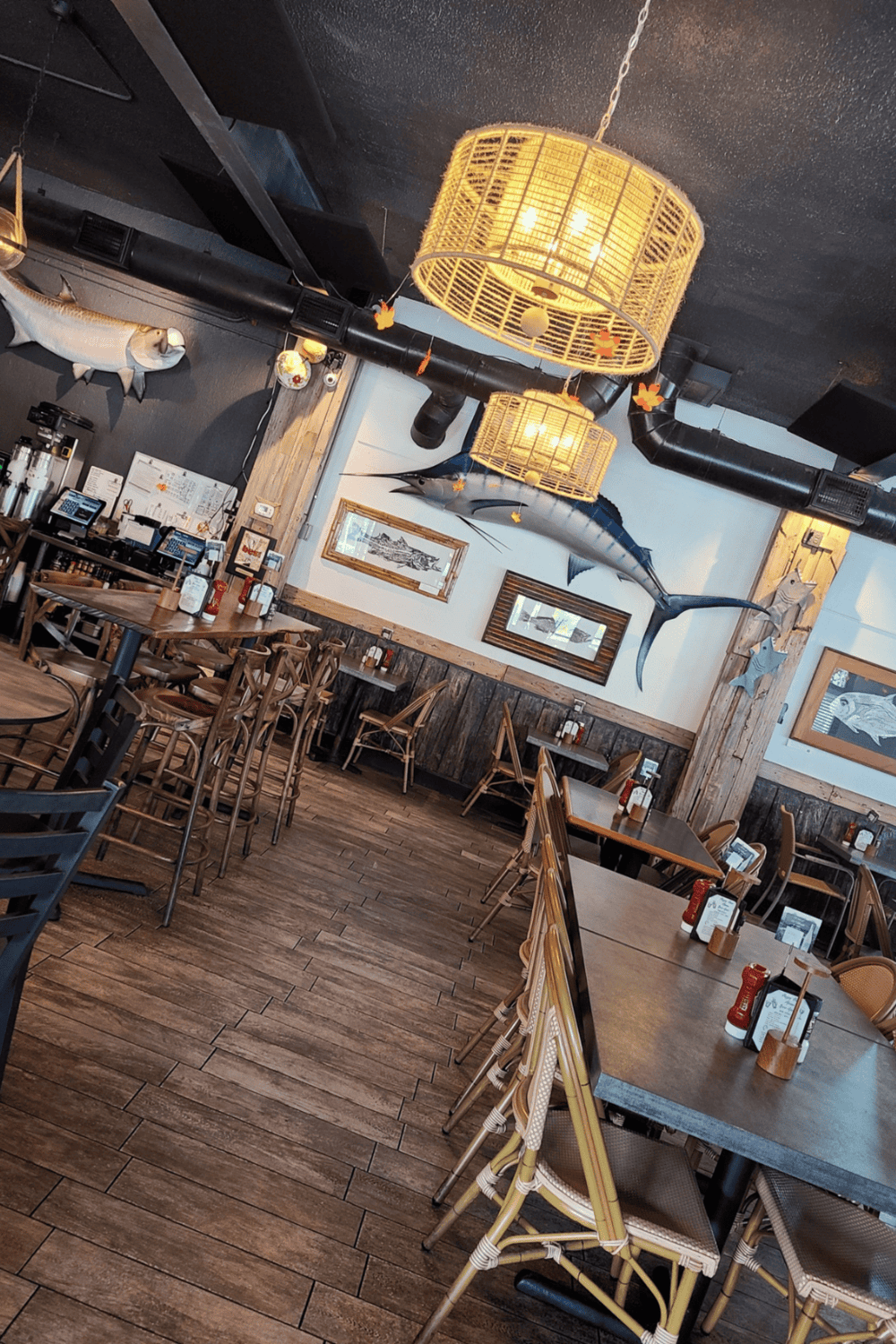 Colorful seafood-themed restaurant interior with mounted fish art and nautical decor.