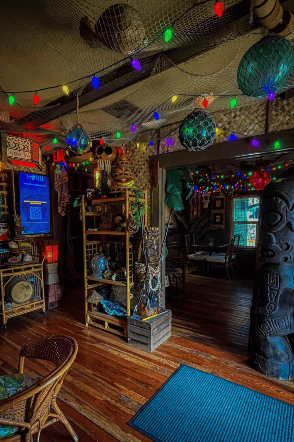 Colorful tropical tiki bar decorated with vibrant string lights and Polynesian-themed decor.