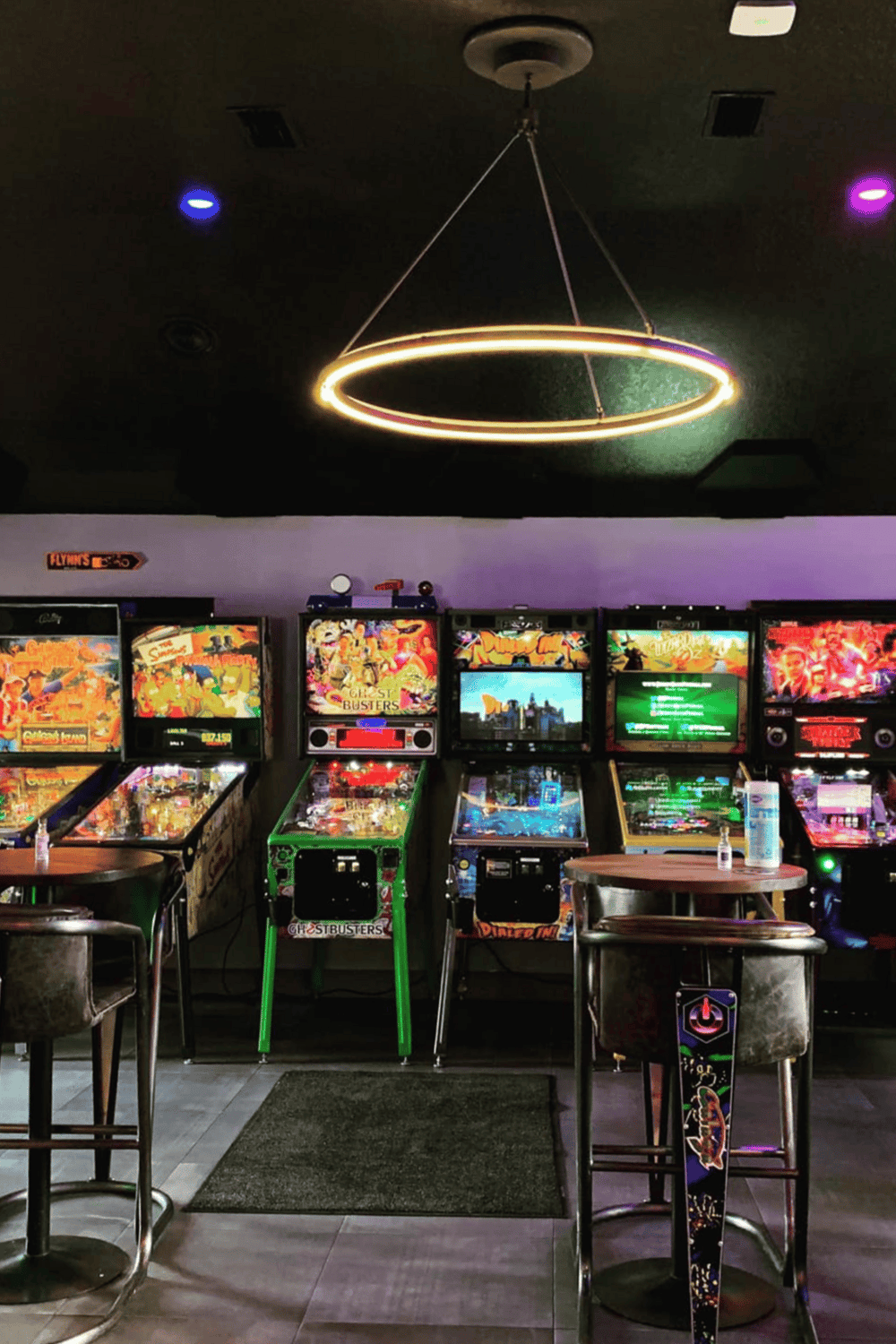 Vintage arcade pinball machines at Quest for Directions gaming lounge with modern lighting, perfect entertainment destination.