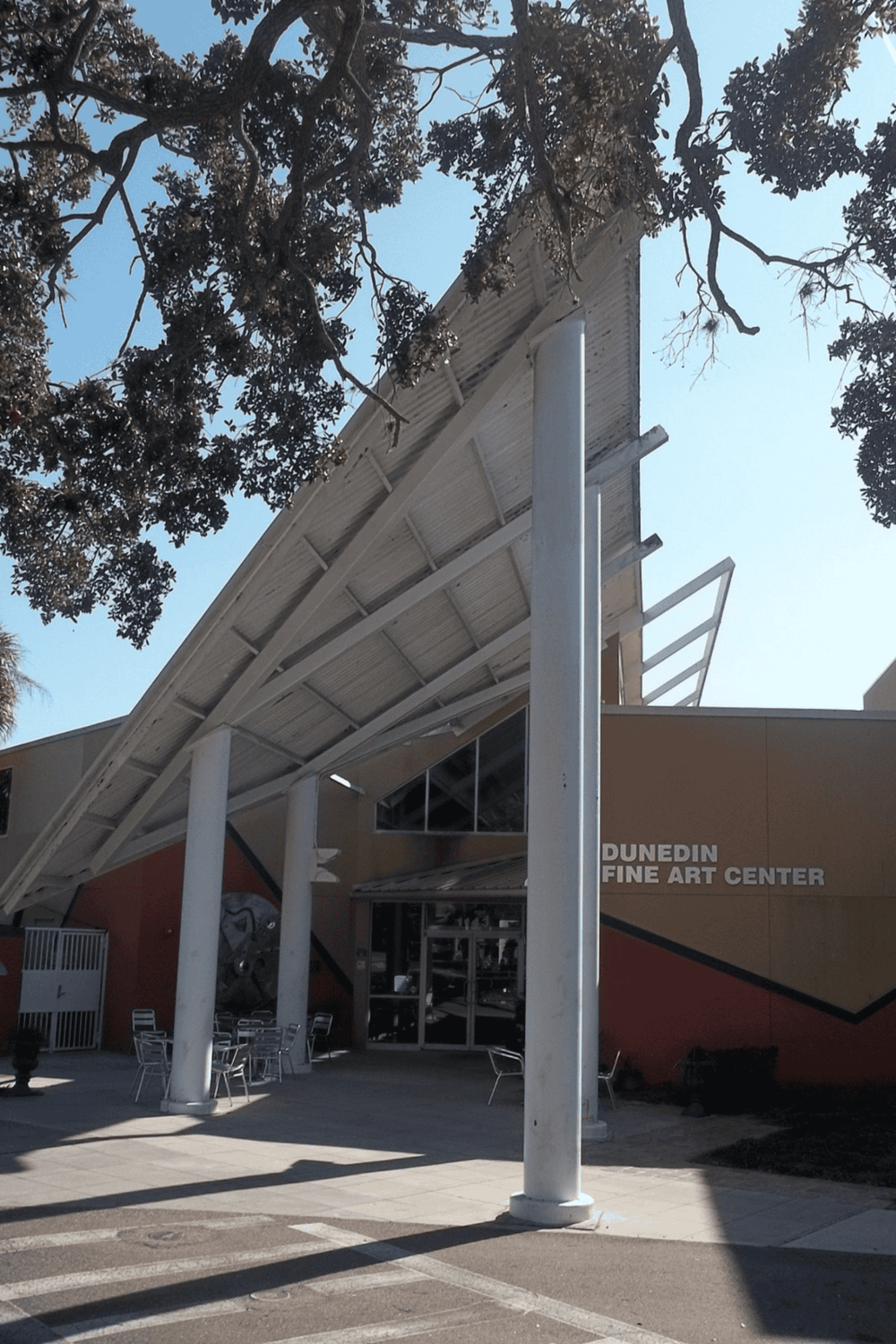 Modern art center with geometric architectural design and outdoor seating, located in Dunedin, Florida.