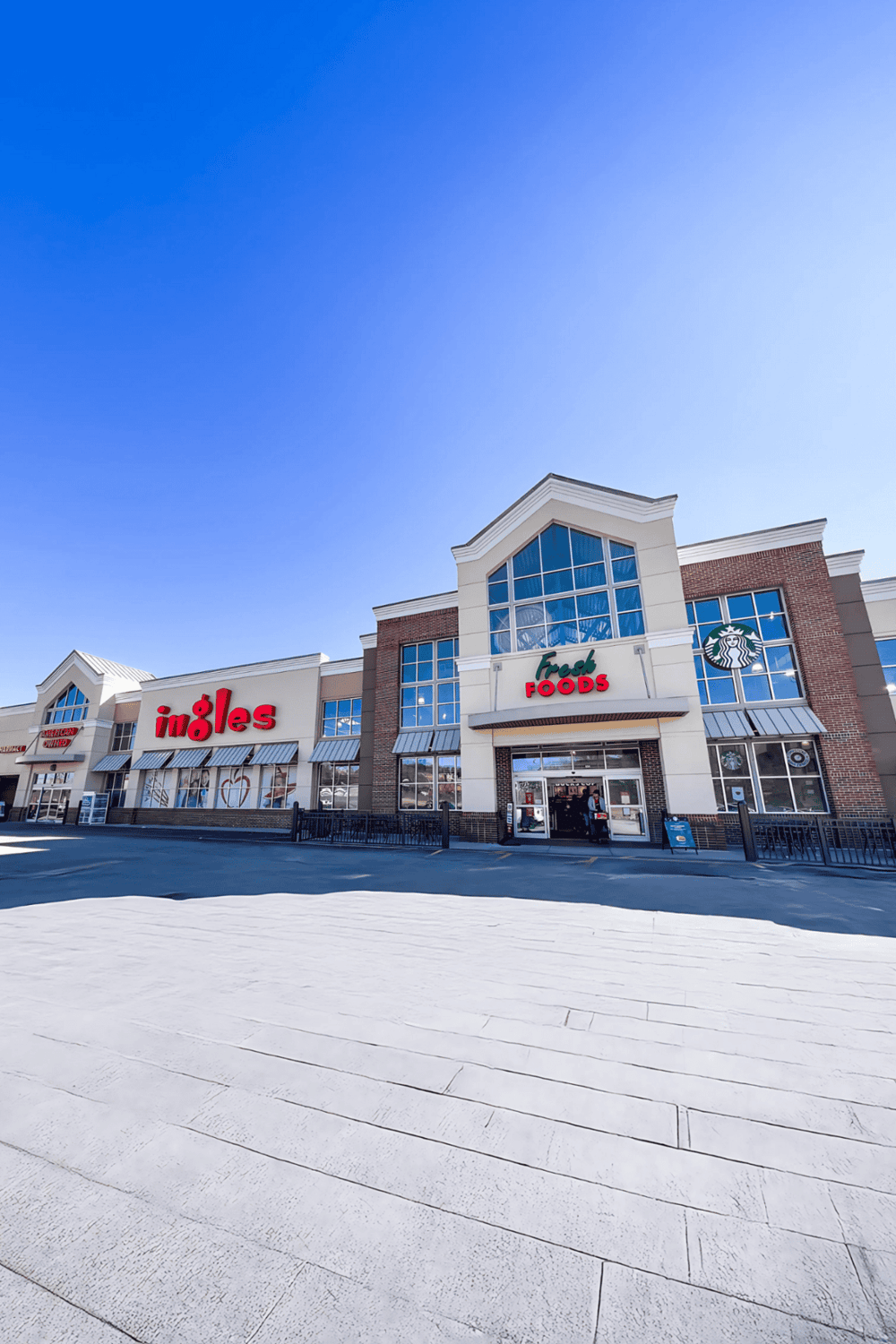 1. Modern retail store entrance with Ingle's, Fresh Foods, and Starbucks signage in shopping plaza.