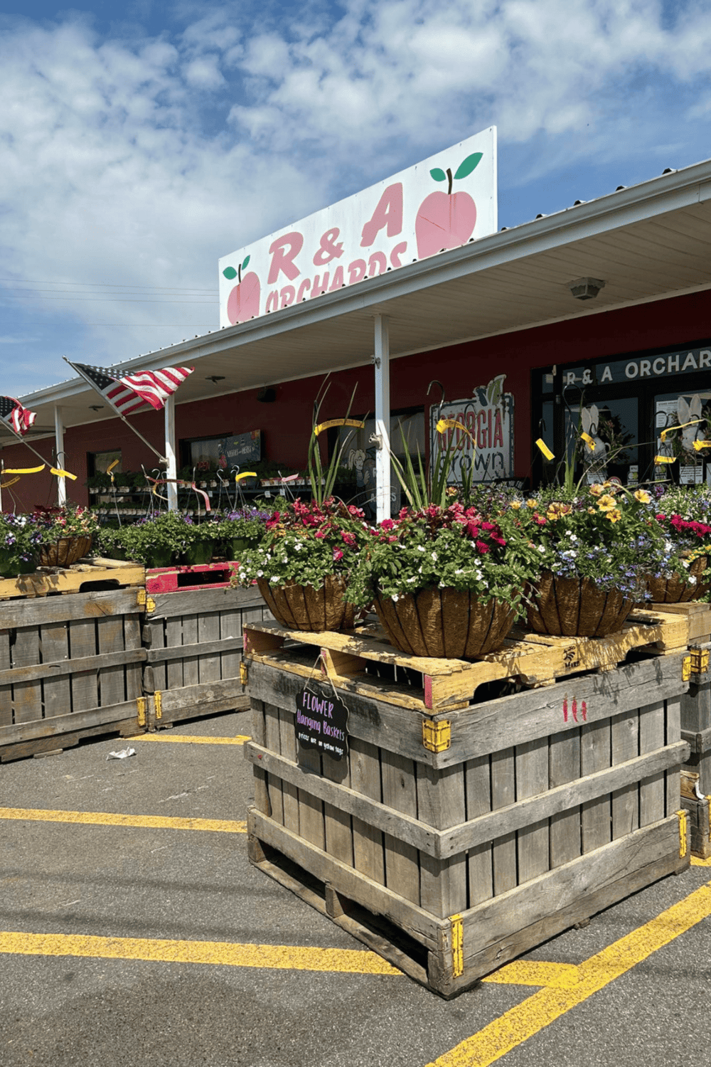 Colorful flower baskets outside R & A Orchards.