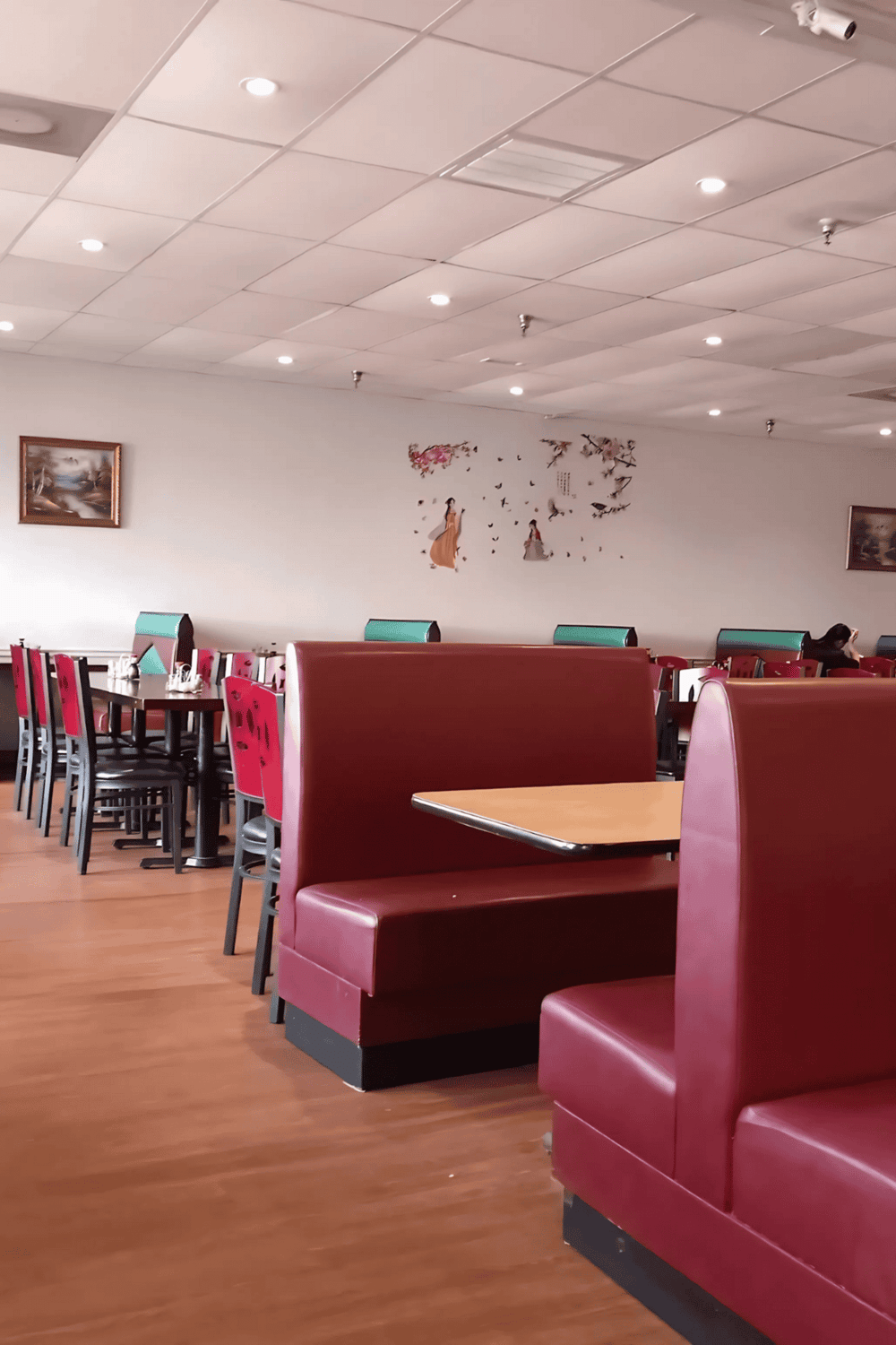 Comfortable restaurant seating with red booths and modern decor.