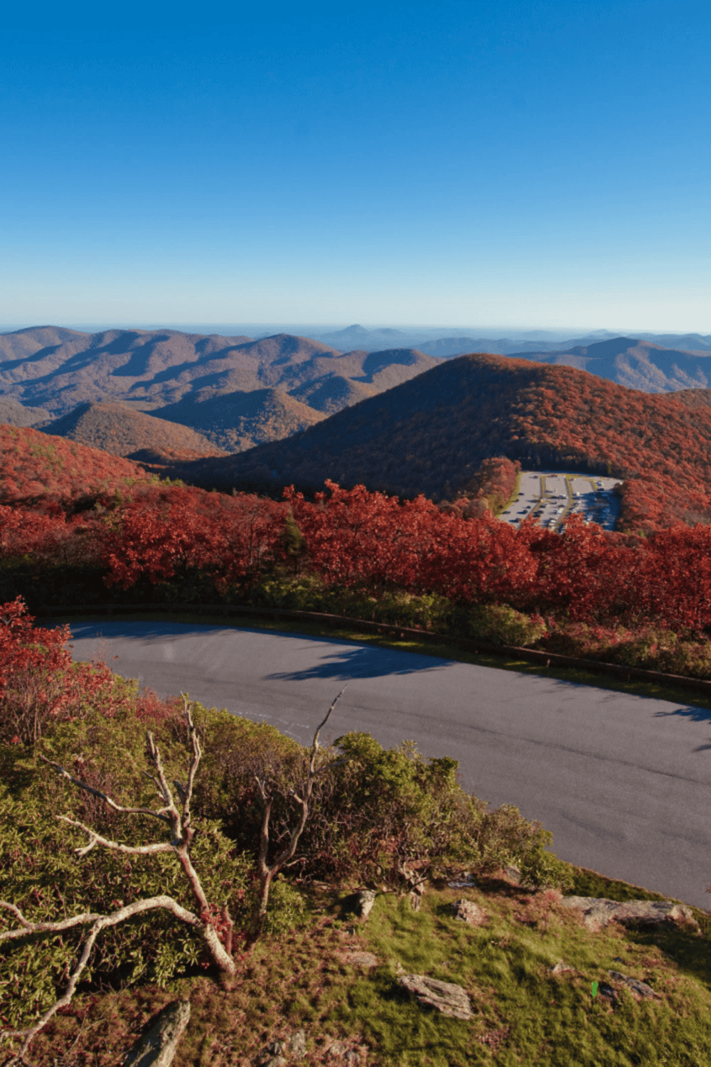 Breathtaking mountain view with colorful autumn foliage and clear blue sky, perfect for fall hiking and outdoor adventures.