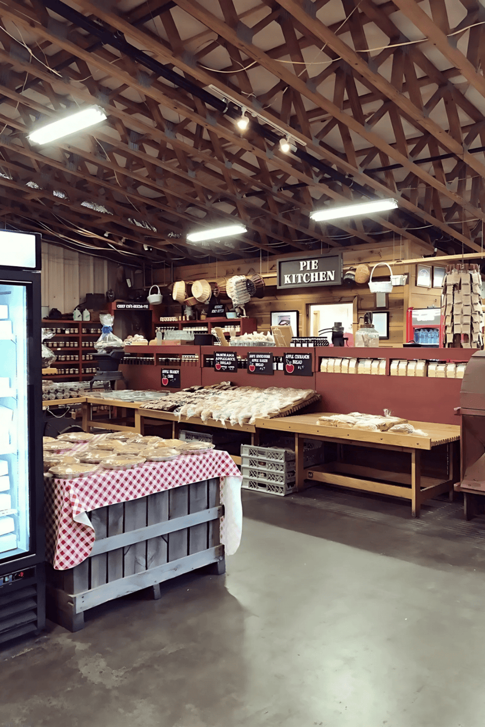 Freshly baked pies in pie kitchen display with rustic decor and wooden shelves for sale.