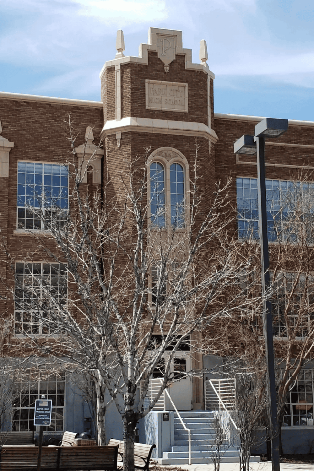 Historic high school building with brick architecture and large windows.