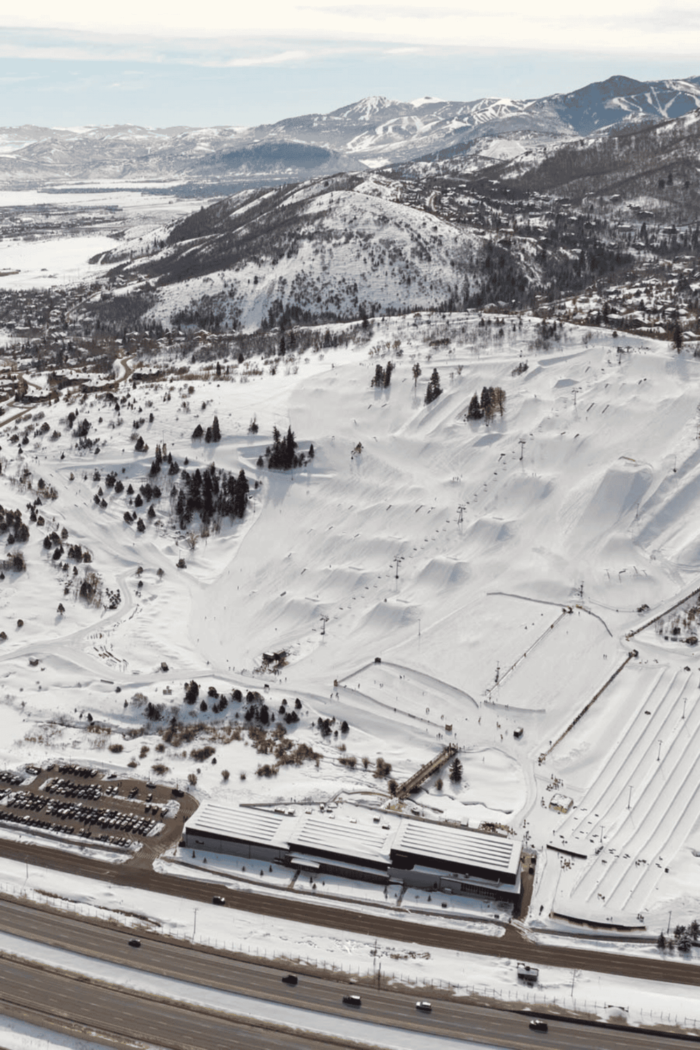 Snowy mountain ski resort with ski lifts and trails in winter scenery.