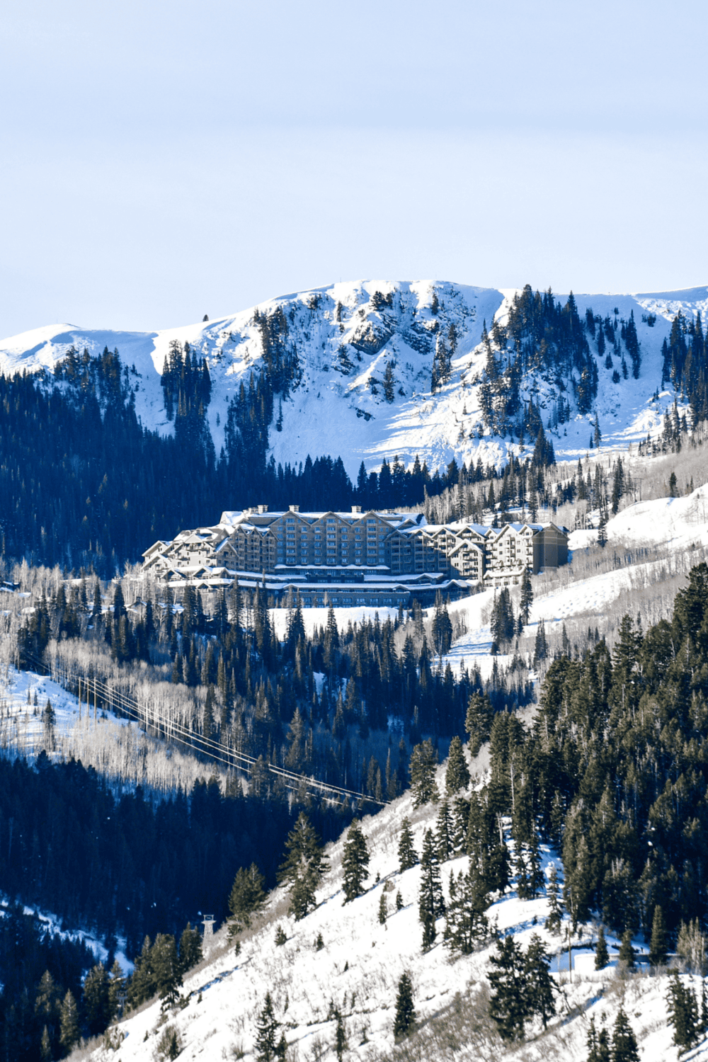 Observation deck overlooking snowy mountain resort and pine forest at QuestForDirections.