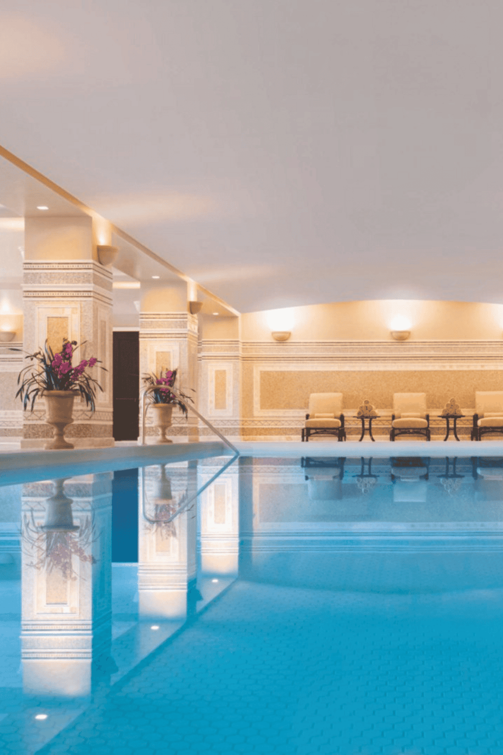 Luxurious indoor swimming pool with elegant decor and ambient lighting at Quest for Directions resort.