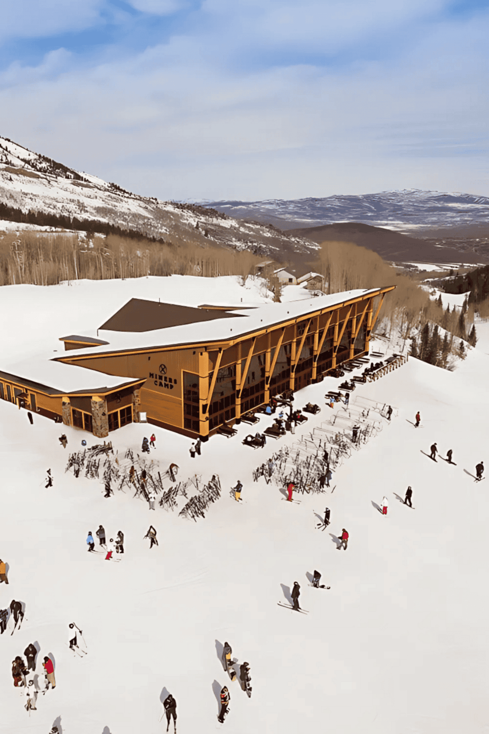 Snowy mountain ski lodge with skiers and winter landscape, outdoor adventure activities, and scenic mountain views.