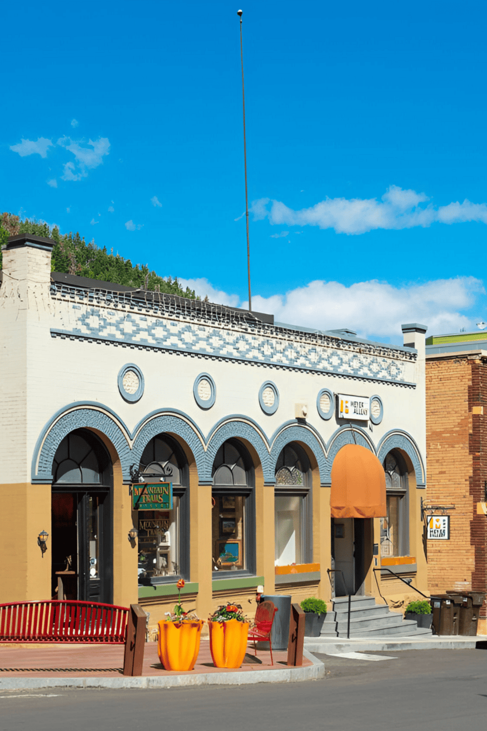 Historic building with colorful façade and outdoor seating in downtown area.