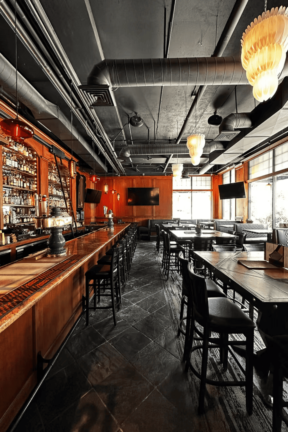 Stylish modern bar with wooden accents, black ceiling, and ambient lighting for dining and drinks.