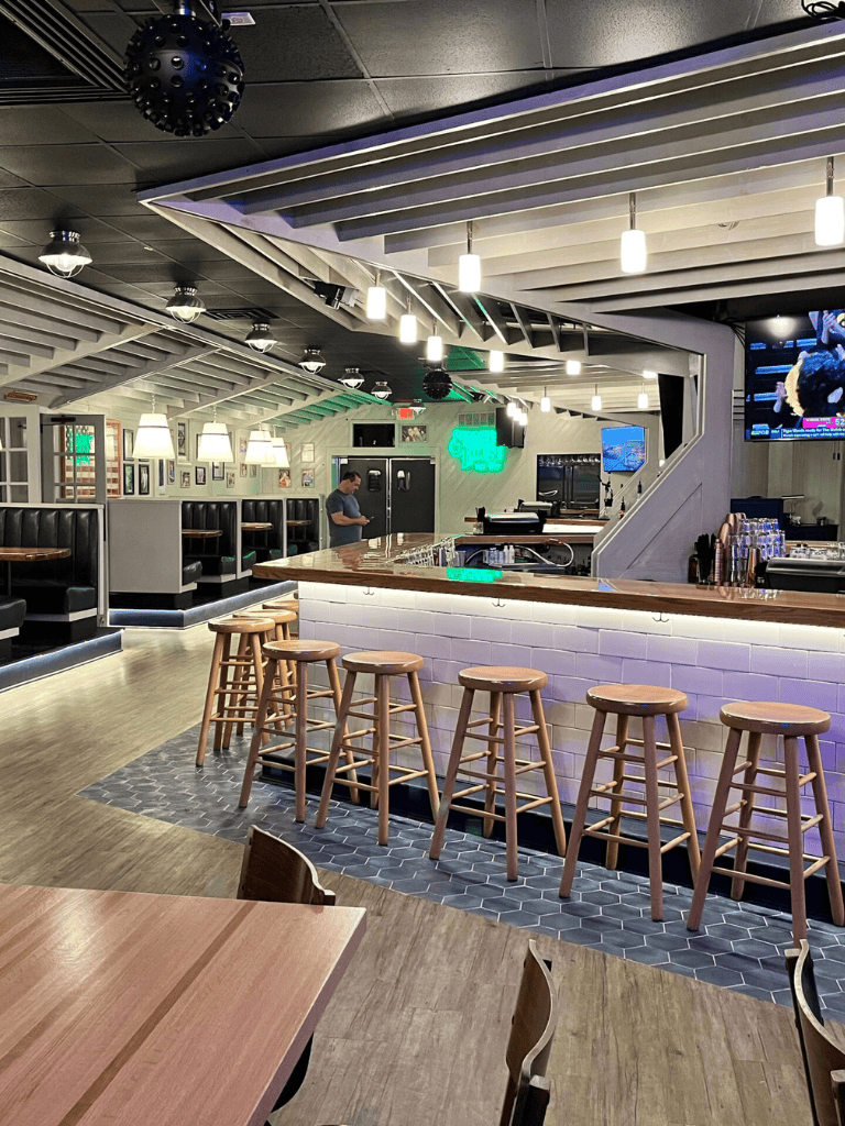 Bar interior at QuestForDirections restaurant, modern design with cozy lighting.