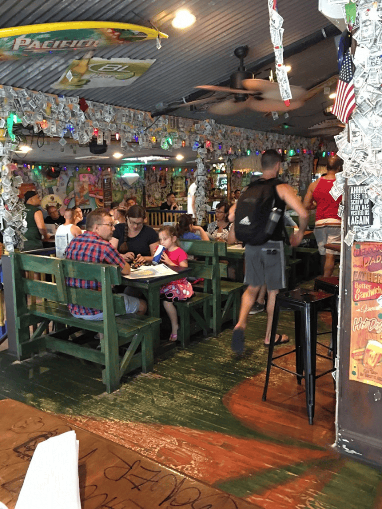 Colorful restaurant interior with diverse diners, lively atmosphere, and vibrant decor showcasing QuestForDirections ambiance.