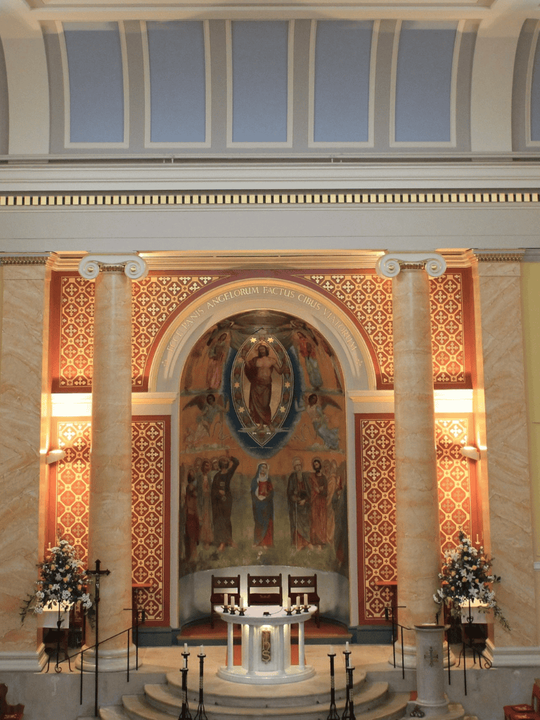 1. Beautiful church altar with religious murals, candles, and floral decorations for worship.