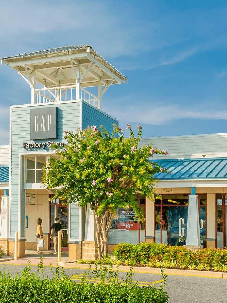 Relaxed shopping scene at GAP Factory Store with bright exterior and welcoming entrance.