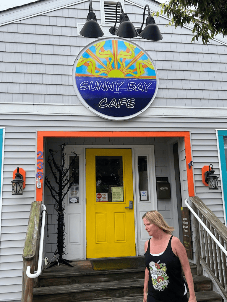 Sunny Bay Café exterior entrance with colorful signage and welcoming vibe.