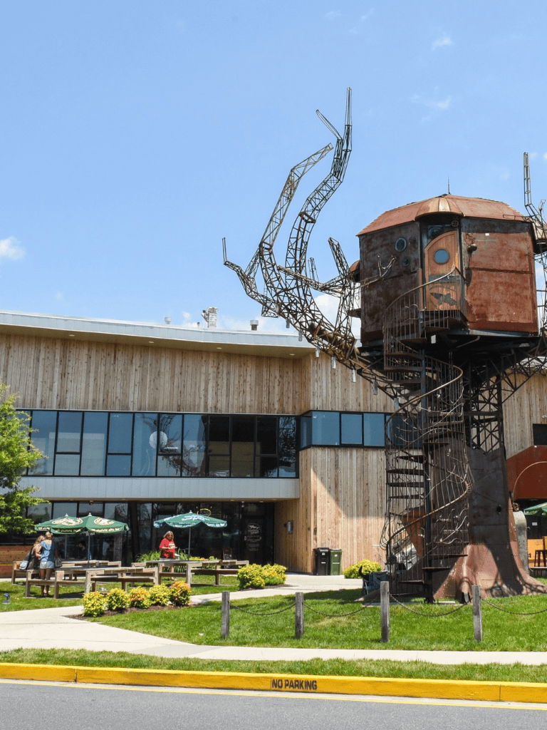 Rustic treehouse sculpture with observation deck at QuestForDirections outdoor venue, outdoor seating, modern architecture, Visitor attractions.